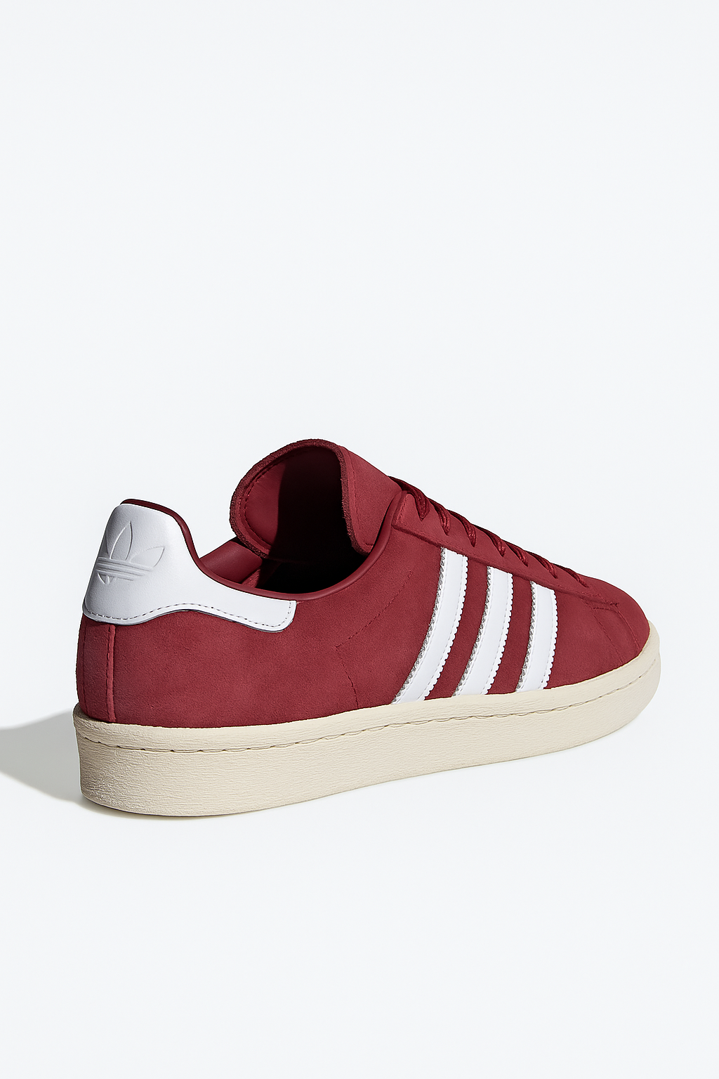 Maroon Adidas Campus 80s shoes with white leather heel tab, three white stripes, nubuck upper, and rubber sole, viewed from the side.