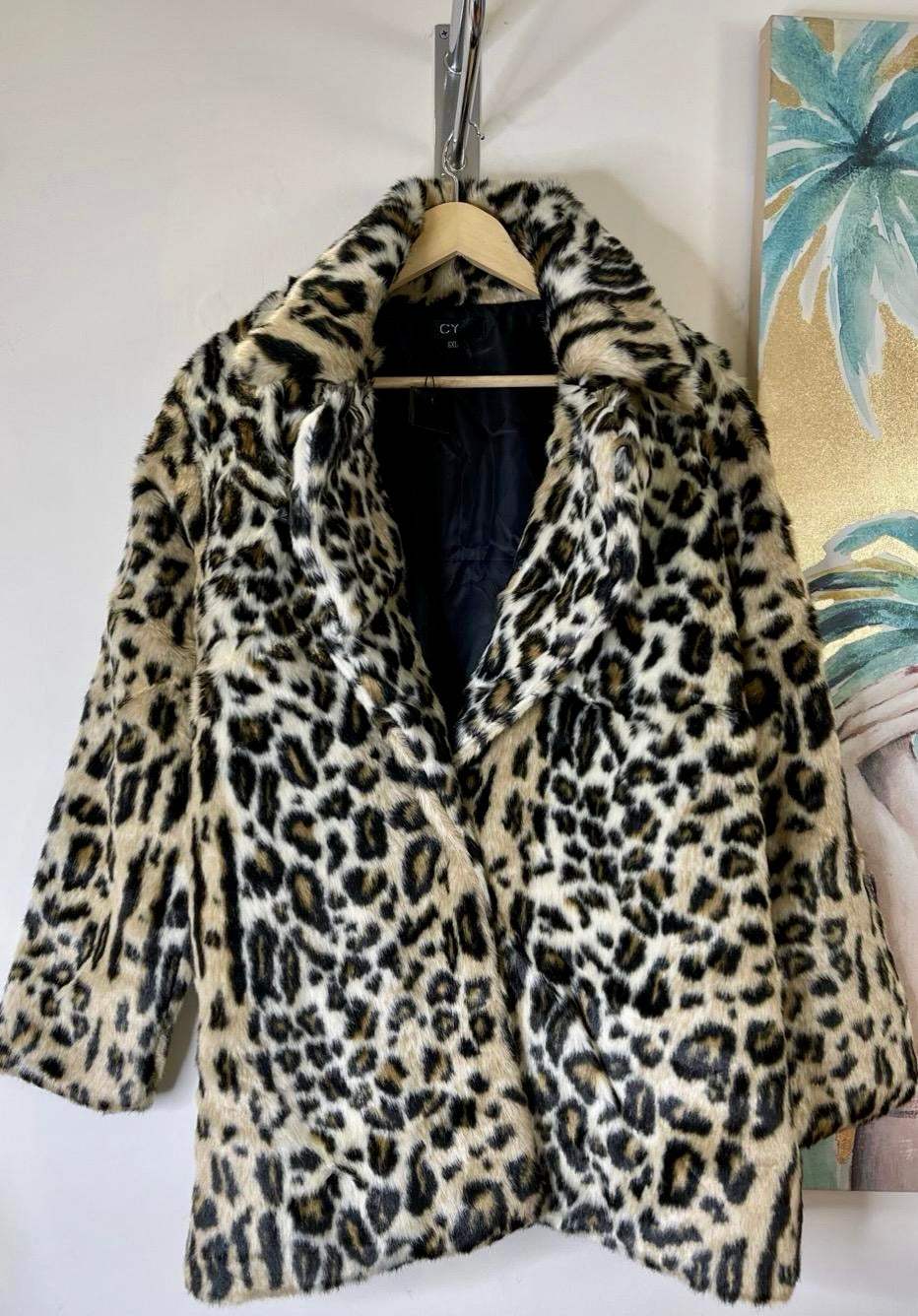 Faux fur leopard print jacket with soft acrylic fabric and side pockets hanging on a wooden hanger