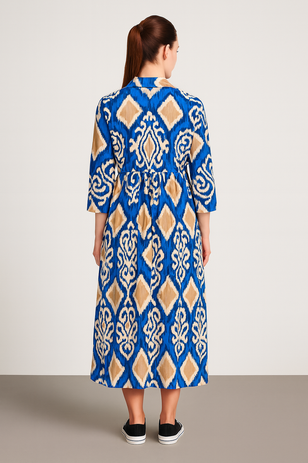 Back view of a woman wearing a blue and beige patterned Italian Collar Button Maxi Dress with three-quarter sleeves and a flowy silhouette.