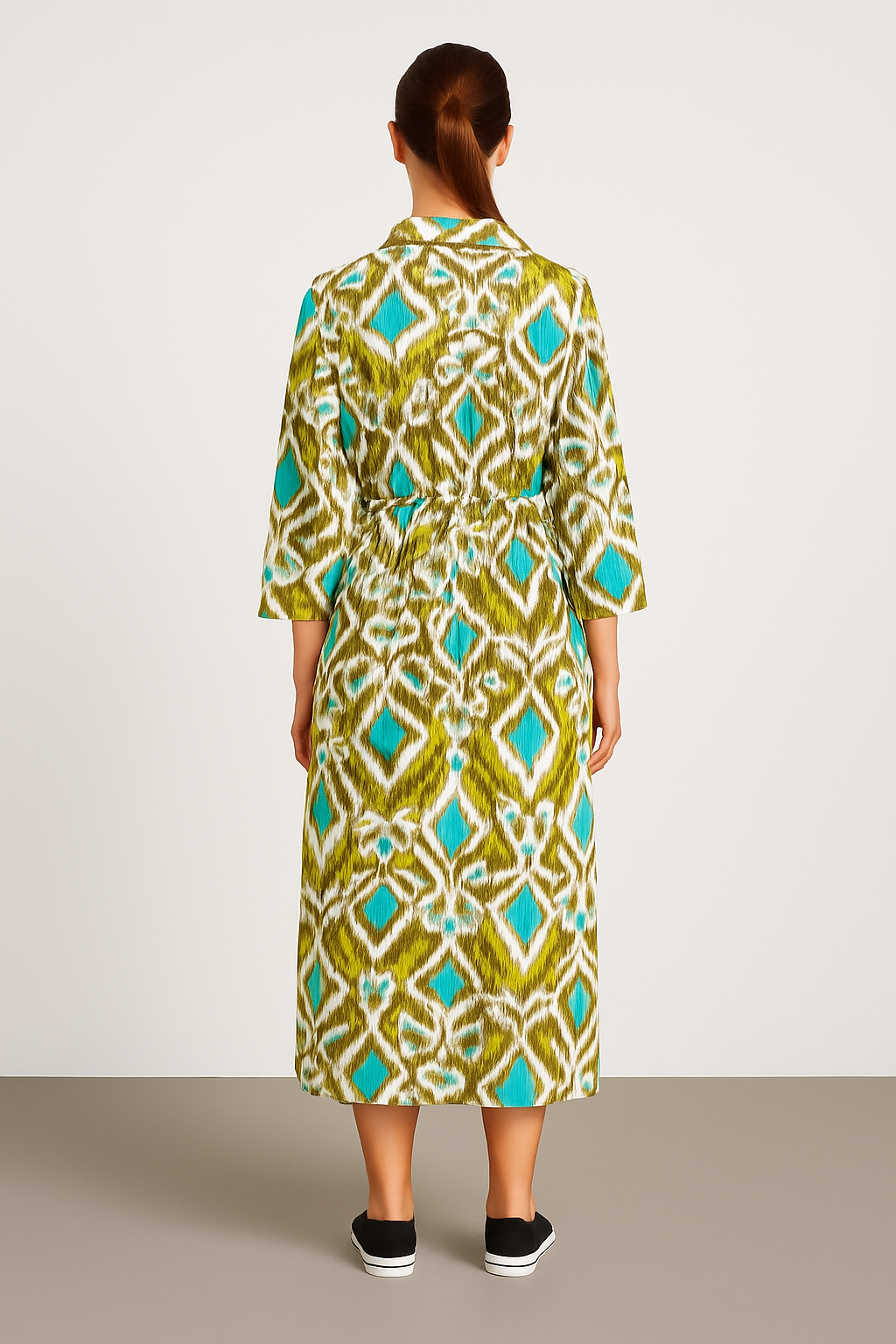 Back view of a model wearing an Italian Collar Button Maxi Dress with green, blue, and white pattern made from lightweight viscose