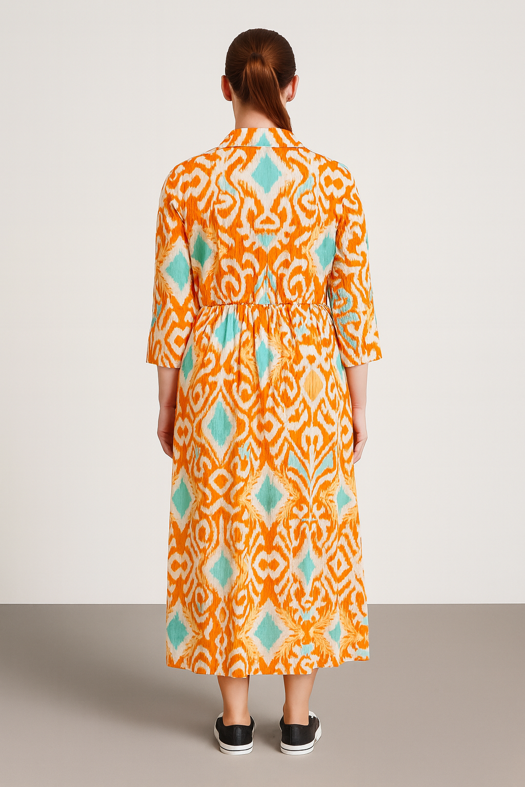 Back view of a woman wearing a colorful patterned Italian Collar Button Maxi Dress with 3/4 sleeves and a flowy silhouette against a plain background