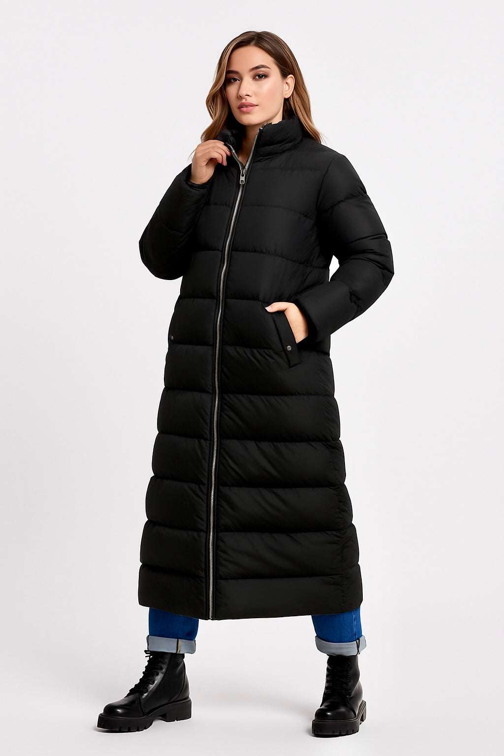 Carlie Longline Puffer Jacket in black, lightweight insulated polyester, with side pockets, worn by woman for autumn and winter warmth and style