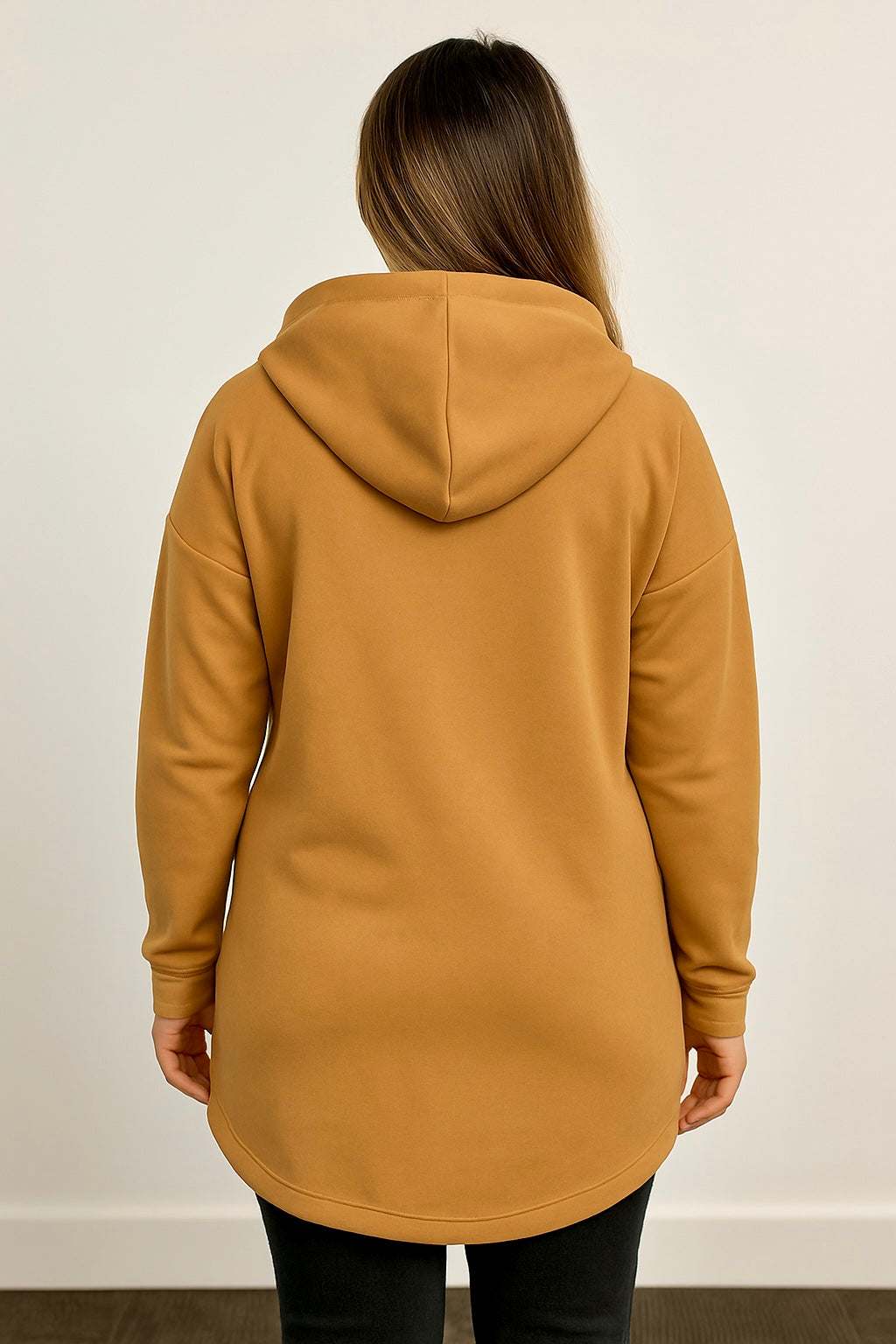 Back view of a woman wearing a camel brown suede feel hoodie with a relaxed fit and hood