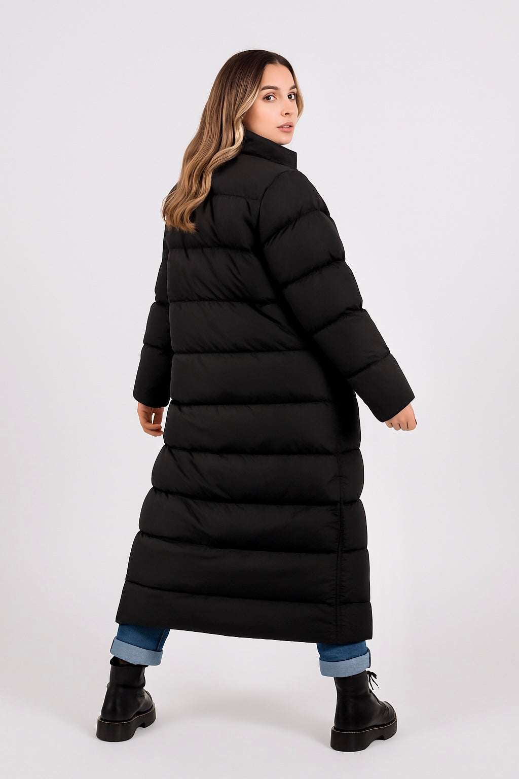 Woman wearing black Carlie longline puffer jacket with side pockets and casual winter outfit