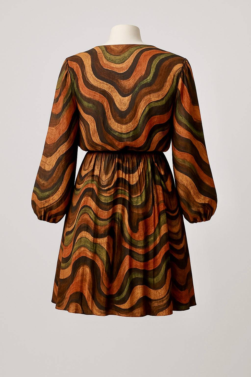 Back view of Marble Pleated Skirt Mini Dress with long sleeves in warm earthy marble print and flowy silhouette.