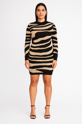 Woman wearing zebra print bodycon knitted dress with long sleeves and round neckline, styled with black high heel sandals