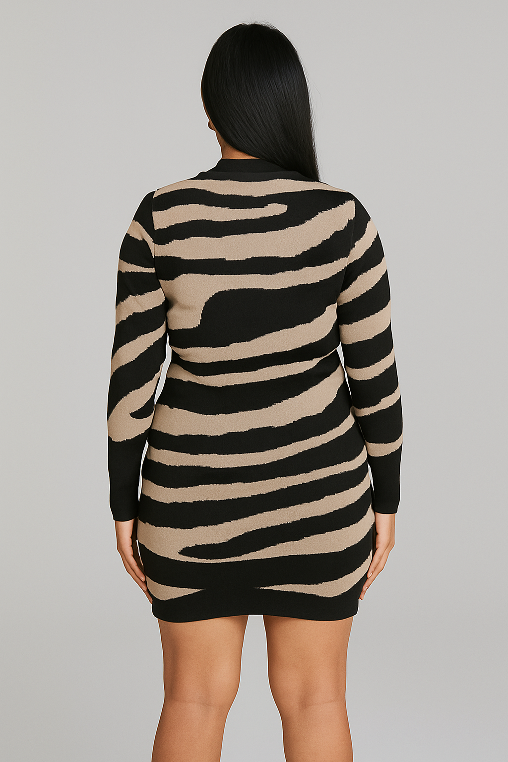 Woman wearing a zebra print bodycon knitted dress, back view, featuring long sleeves and fitted silhouette.