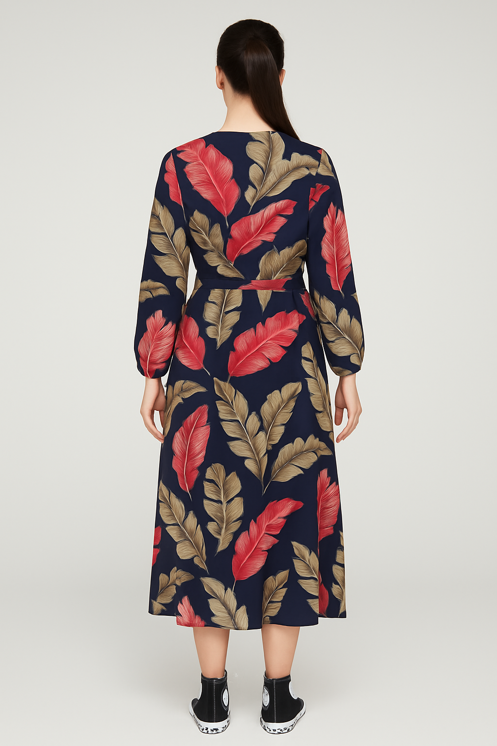 Back view of Jess Floral Wrap Dress in navy with large red and beige leaf print, featuring long sleeves and tie waist, worn with black sneakers