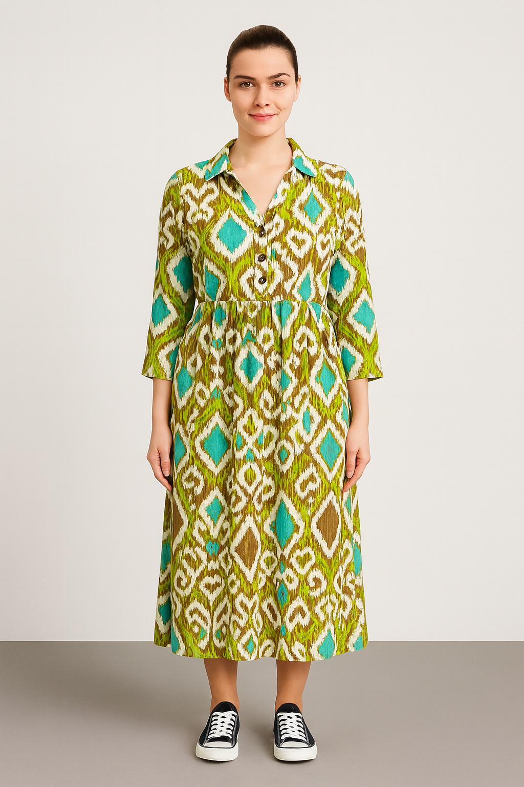 Woman wearing a green and blue patterned Italian collar button maxi dress with 3/4 sleeves and sneakers
