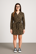 Woman wearing leopard print belted dress with long sleeves and collared neckline paired with black sneakers