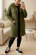 Hailey Hooded Long Cardigan in olive green knit with front pockets, worn over black leggings and sneakers, cozy casual layering knitwear